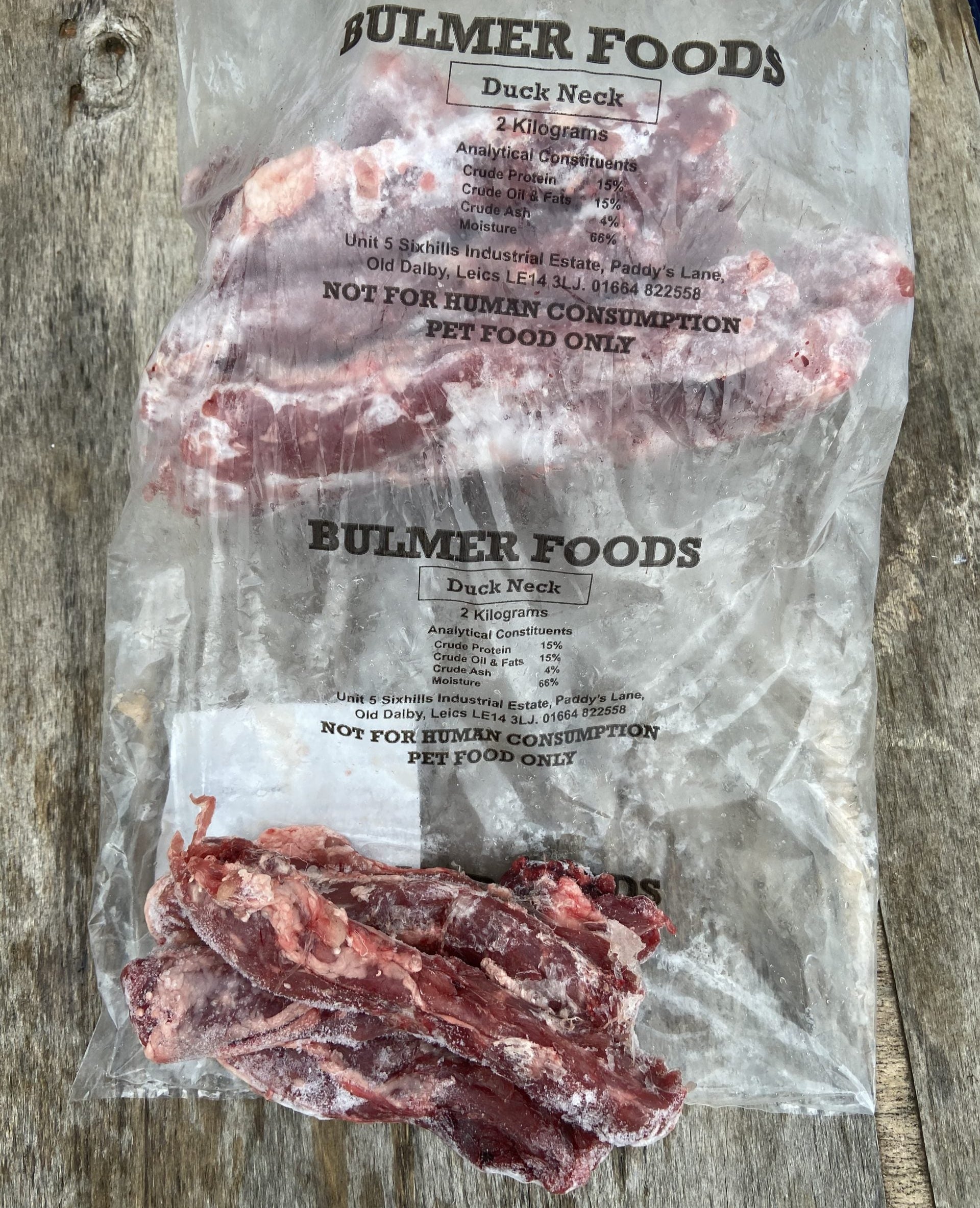 A bag of frozen, raw duck necks branded as Bulmer Foods for pet food