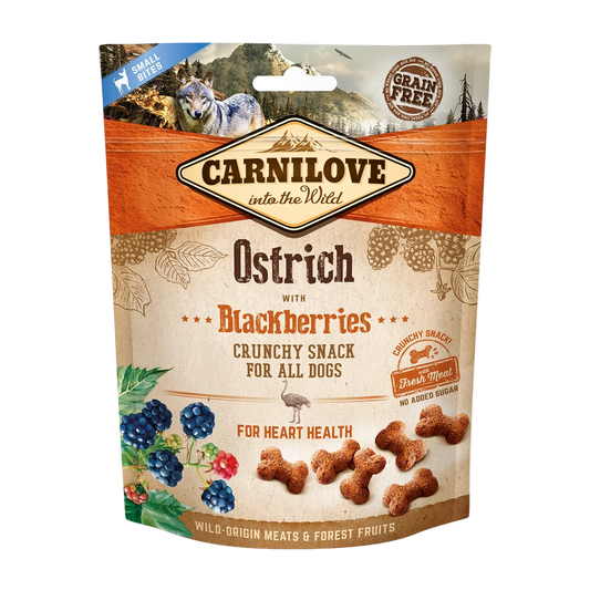 Carnilove Ostrich with Blackberries crunchy snack packaging for dogs on a white background. packaging has a background of mountain and forest environment with an image of a wolf.