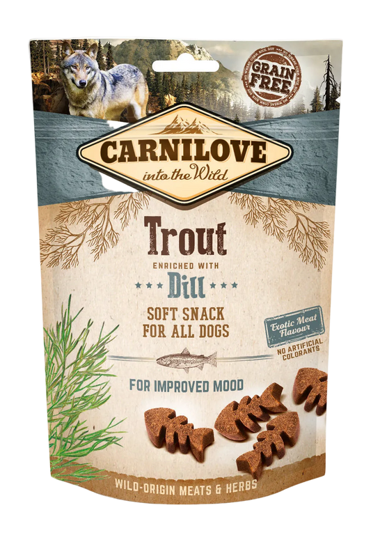 Carnilove dog snack package with a wolf illustration on a forest & mountain environment background
