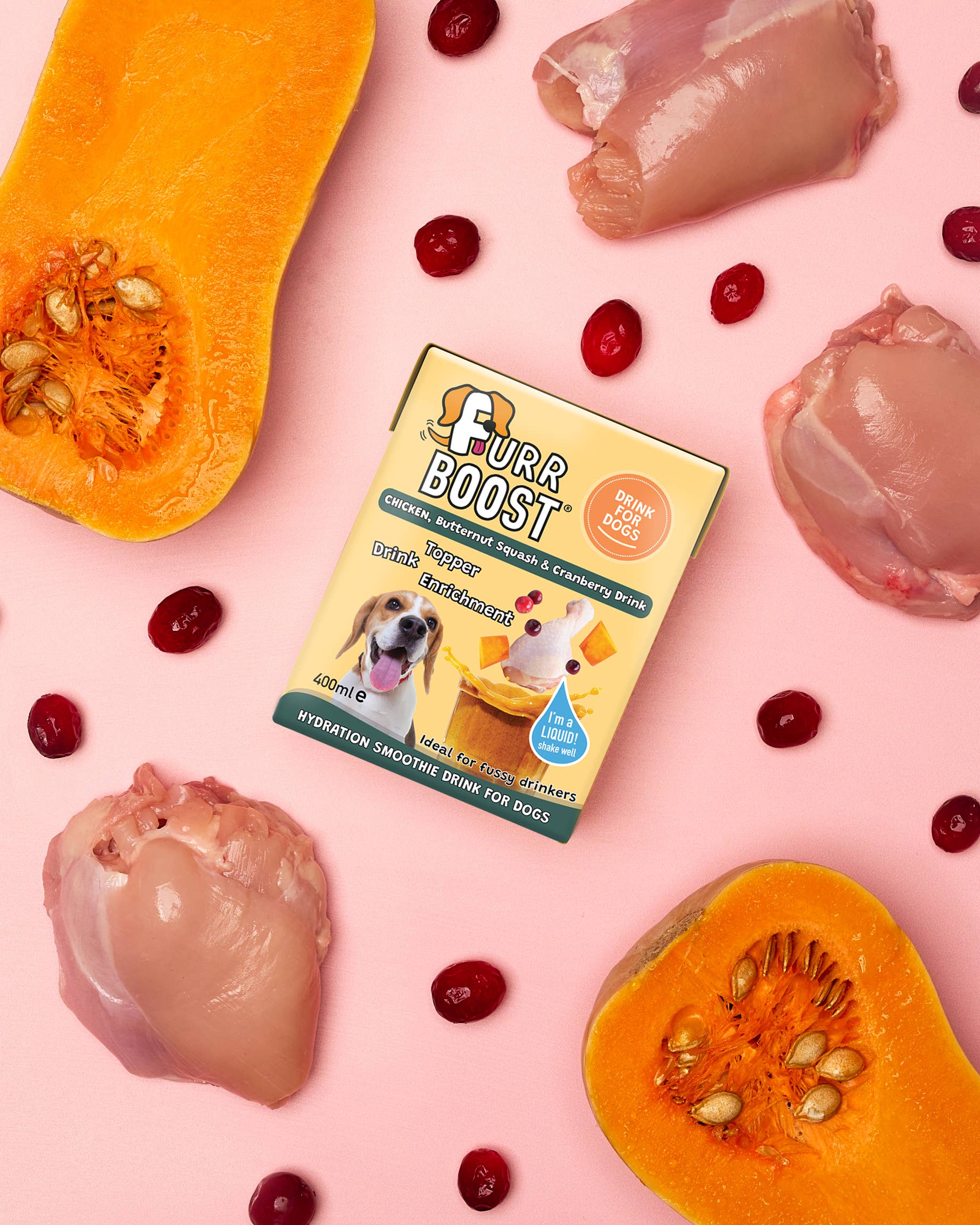 Furr Boost supplement box surrounded by chicken pieces, cranberries, and pumpkin on a pink background