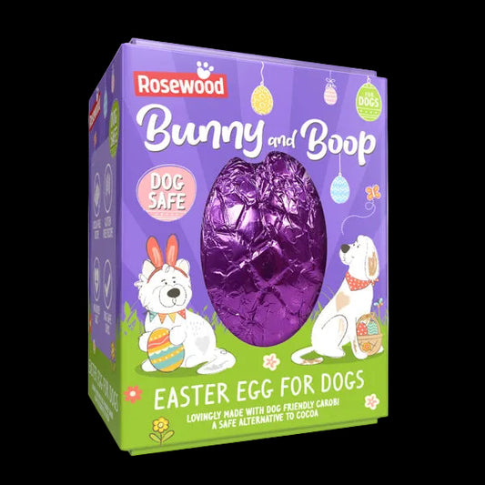 Chocolate-like Easter egg wrapped in purple foil, inside a box decorated with graphics of dogs in Easter seasonal wear.